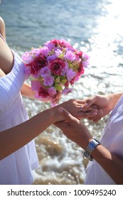 Royalty High Quality Free Stock Image Of Groom Holding Bride Hand And Flower In Sunshine On The Beach. Beautiful Couple