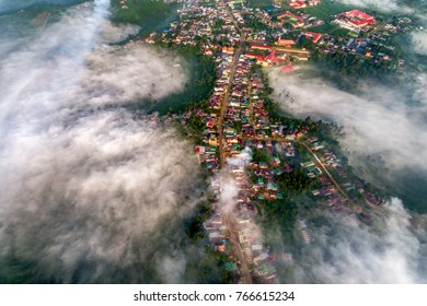Royalty high quality stock image aerial view of Bao Loc town, Lam Dong, Vietnam. Fog, mountain and city