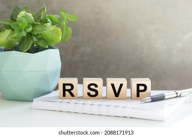 rsvp acronym request for a response from the invited person on wooden cubes on the office table.
