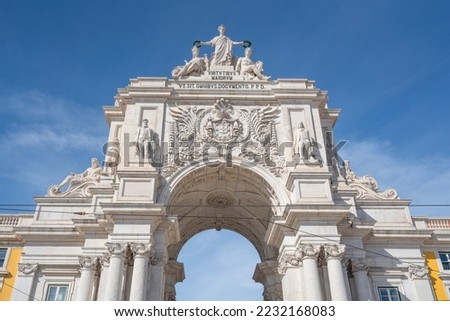 Rua Augusta Arch at Praca do Comercio Plaza - Text says: "To the Virtues of the Greater, to serve all as teaching" - Lisbon, Portugal