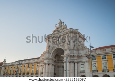 Rua Augusta Arch at Praca do Comercio Plaza - Text says: "To the Virtues of the Greater, to serve all as teaching" - Lisbon, Portugal