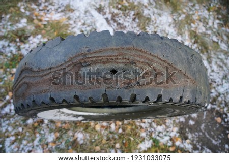 rubbed wheel of a lorry. worn wheel with a hole in the tire, worn rubber tread to the cord