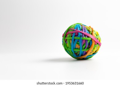 Rubber ball out of many colorful elastic bands on white background. Empty space