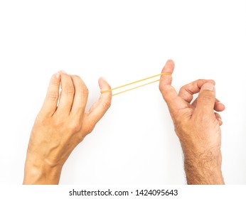 Rubber Band Being Stretched By Two Hands Of Different People On A White Background