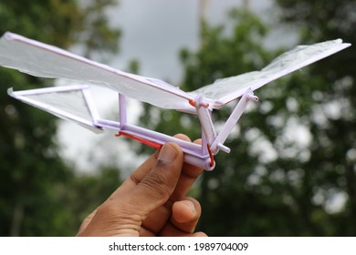 Rubber Band Power Ornithopter Held In Hand On Nature Background