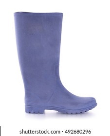 Rubber boots in blue with an embossed sole. It stands on a white background in the studio.
