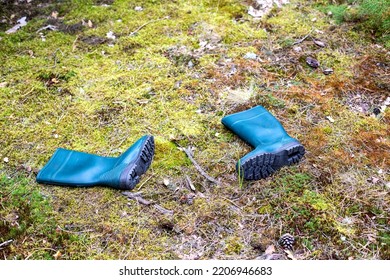 Rubber Boots Lie In The Forest On The Ground. Missing Person Concept. An Accident In The Forest. Attack Of A Wild Animal. Danger