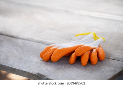 Rubber Coated Cotton Work Gloves On Wooden Table 