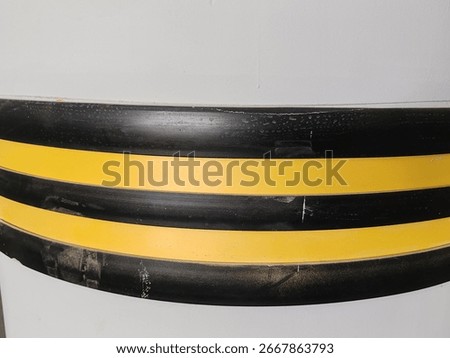 Rubber corner guard.
Rubber corner protector or wall angle protector safety infrastructure.
Black and yellow corner guards on a concrete pillar indoor parking garage.
Rubber bumper on Car parking.