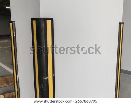 Rubber corner guard.
Rubber corner protector or wall angle protector safety infrastructure.
Black and yellow corner guards on a concrete pillar indoor parking garage.
Rubber bumper on Car parking.