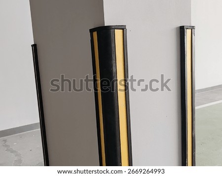 Rubber corner guard.
Rubber corner protector or wall angle protector safety infrastructure.
Black and yellow corner guards on a concrete pillar indoor parking garage.
Rubber bumper on Car parking.