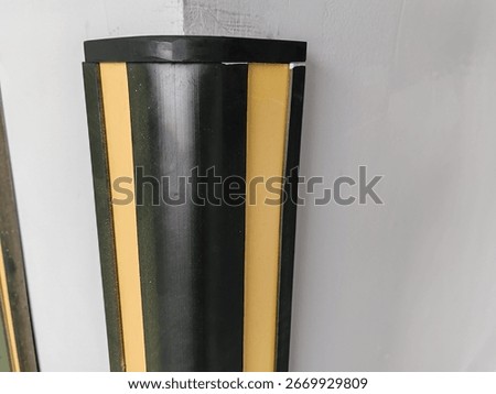 Rubber corner guard.
Rubber corner protector or wall angle protector safety infrastructure.
Black and yellow corner guards on a concrete pillar indoor parking garage.
Rubber bumper on Car parking.