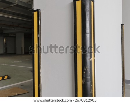 Rubber corner guard.
Rubber corner protector or wall angle protector safety infrastructure.
Black and yellow corner guards on a concrete pillar indoor parking garage.
Rubber bumper on Car parking.