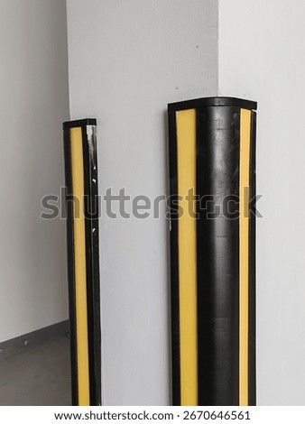 Rubber corner guard.
Rubber corner protector or wall angle protector safety infrastructure.
Black and yellow corner guards on a concrete pillar indoor parking garage.
Rubber bumper on Car parking.