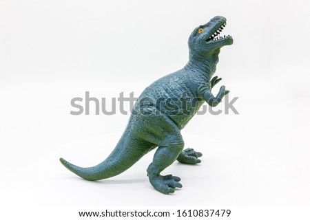 Rubber dinosaur toy. Prehistoric wild animal, danger beast, T-Rex. Isolated on white background.