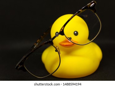 Rubber Duck With Glasses On A Black Background