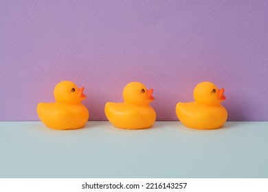 Rubber Ducklings On A Pastel Two Tone Background. Minimal Summer Concept