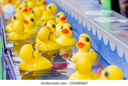 Rubber Ducks Floating In Water At A Carnival