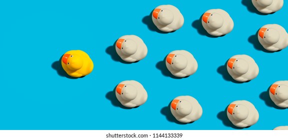 Rubber Ducks Leadership Concept On A Blue Background