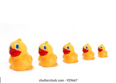 Rubber Ducks In A Row On White Background