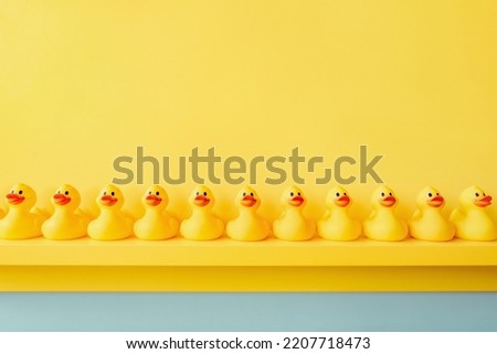 Rubber ducky bath toy background yellow ducks in a row. Rubber duck background team meeting. Yellow rubber duck in a line toy design yellow concept team work together. Community. Teamwork. Cooperation