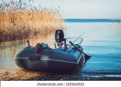 Rubber Fishing Boat On A Tranquil Lake Shore.