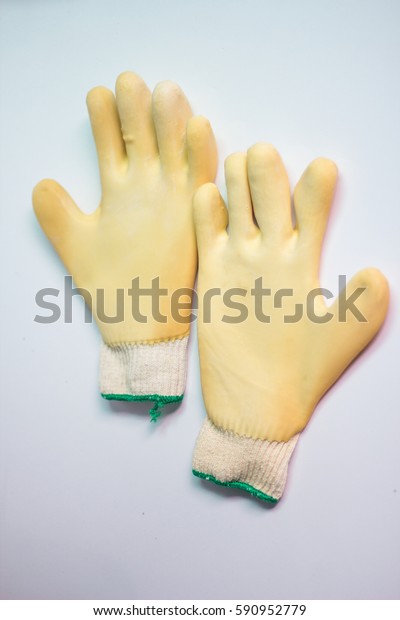 Rubber gloves\
holding a white glass\
background.