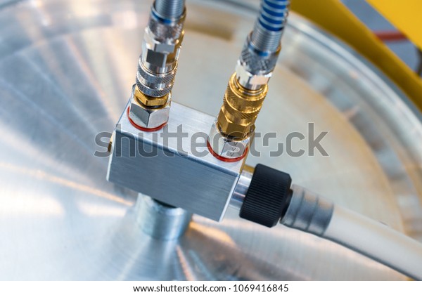 Rubber hydraulic hoses, connected\
to industrial equipment. Abstract industrial\
background.