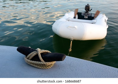 Rubber inflatable dinghy boat towed to a boat. in the middle of the ocean. No people. Copy space
