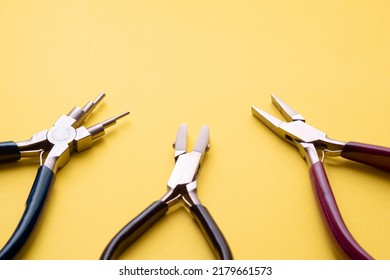 a rubber nose plier, a flat nose plier and a multi-purpose plier on a yellow background