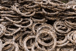 Rubber Rings Covered In Barnacles And Used For Farming Oysters Are Stacked Up On A Beach At The Oyster Farm At Lap An Lagoon, Vietnam.