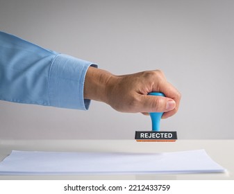 Rubber stamp, hand pressing on paper, with word Rejected. - Shutterstock ID 2212433759