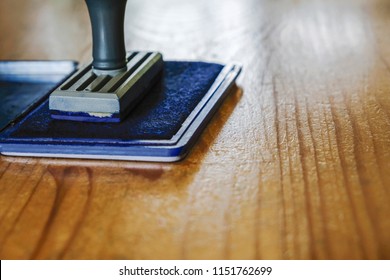 Rubber stamp on the wooden table - Shutterstock ID 1151762699
