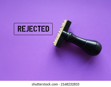 Rubber stamp with stamp words REJECTED on purple background, means refuse to agree to request, not given approval or acceptance to work or offer