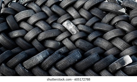 Rubber Tire Recycling. Old Used Car Tires  At A Junkyard In Piles Waiting For Recycle.