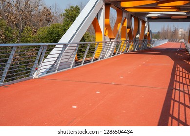 Rubber track under modern steel bridge