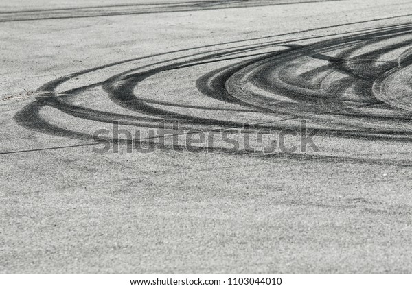 The rubber tracks from the rallye cars left on\
the tarmac in the hairpin. 