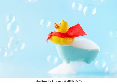 Rubber Yellow Duck In Red Cloak On A Bath Of Foam. Spa Concept. Global Handwashing Day