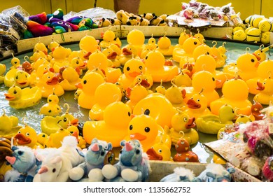 Rubber Yellow Ducks With Hooks In Their Heads. Fairground Hook A Rubber Duck Chance Game.