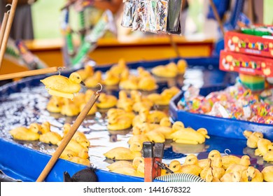 Rubber Yellow Ducks With Hooks In Their Heads. Fairground Hook A Rubber Duck Chance Game