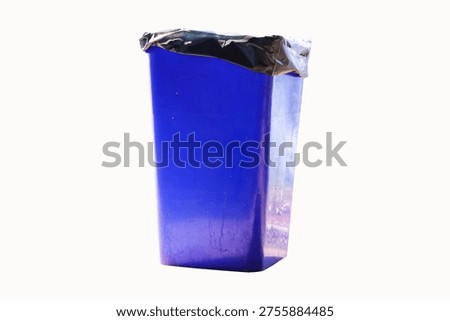 Rubbish bin garbage square shape blue with black plastic bag isolated on white background. Old dirty trash cans plastic. Waste collection equipment in park.