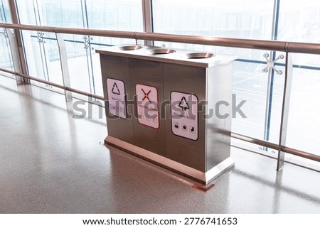 Rubbish bin garbage square shape geometry white plastic with icon 
Residual Waste, Hazardous Waste, Recyclable text read on airport ground on wall is background. Waste collection equipment in park