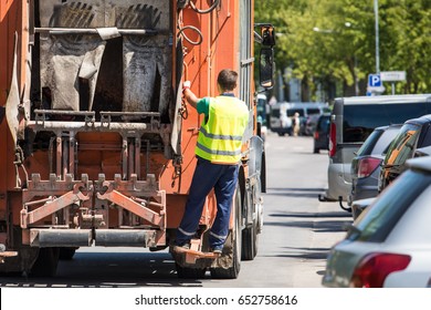 Rubbish Collector Traveling On The Lorry 