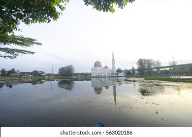 Rubbish Pollution With Plastic And Other Packaging Stuffs On The Lake With Mosque Background. Enviromental Concept.