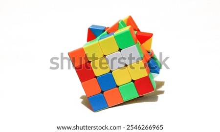 Rubik's cube unsolved and scrambled on a plain white background