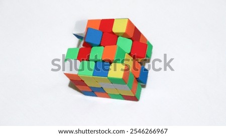 Rubik's cube unsolved and scrambled on a plain white background