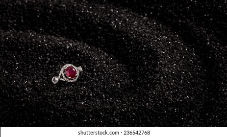 Ruby Ring On A Black Sand Background