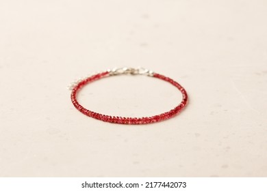 Ruby silver bracelet. Bracelet made of stones on hand from natural stone ruby. Bracelet made of natural stones. Handmade jewelry. Handmade bracelets on light modern background. Thin bracelet.