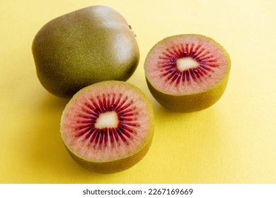 RubyRed Kiwi fruit on a yellow background. Healthy food concept.