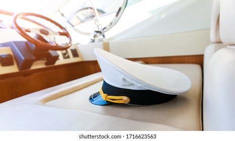 Rudder and captain's hat on yacht.